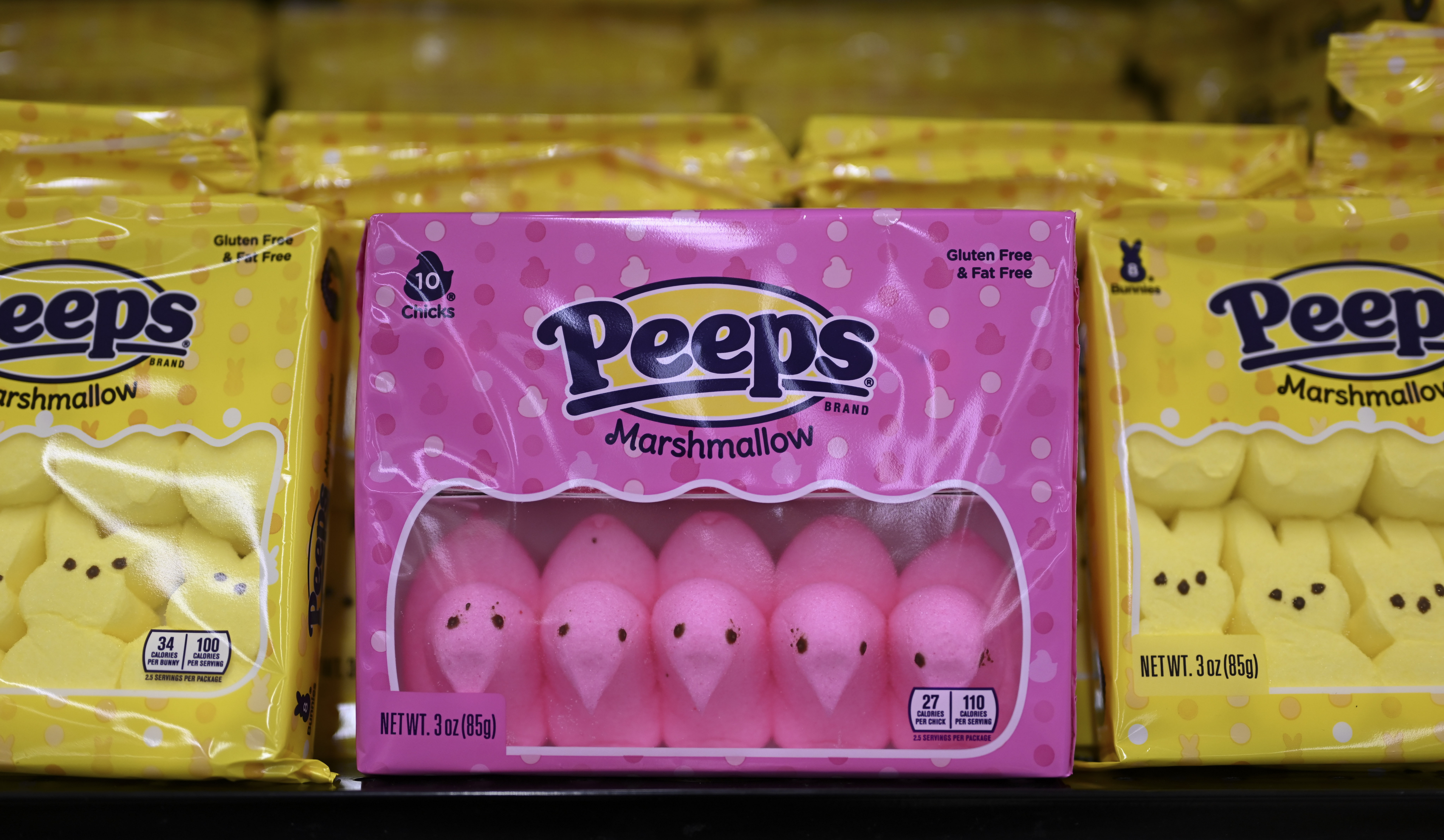 Peeps in their package on a store shelf.